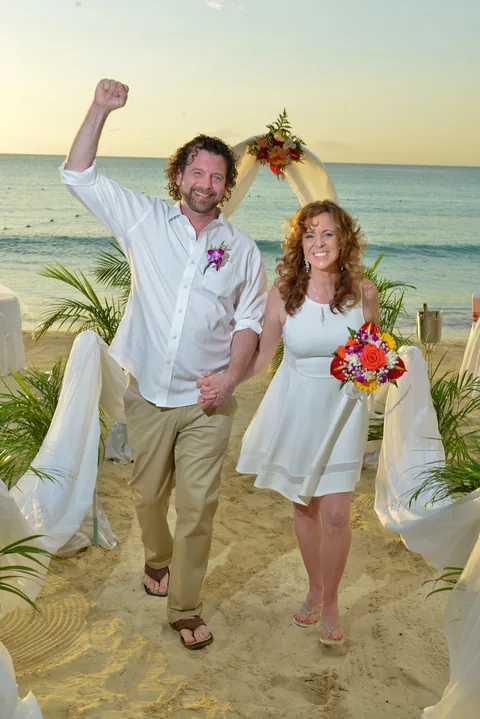 Couple celebrating their beach wedding at CocoLaPalm