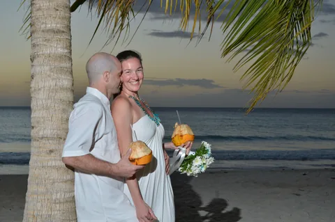 Newlywed couple celebrating on the beach