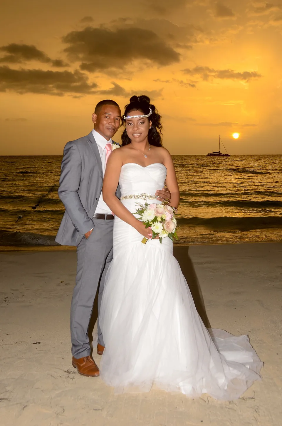 Bride and groom on Seven Mile Beach at sunset