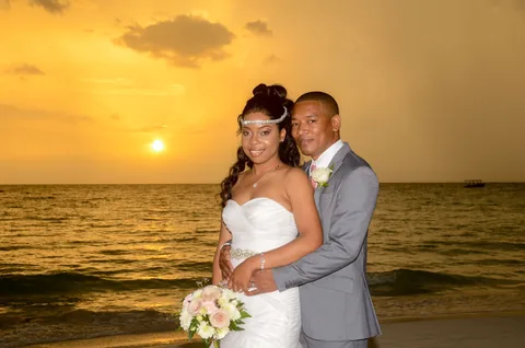 Wedding couple beside the Caribbean Sea at sunset